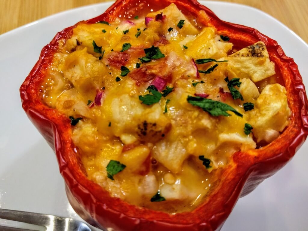 Chicken Stuffed Red Peppers with Cheese, Green Chilies, Habaneros, Radishes and Cauliflower on plate